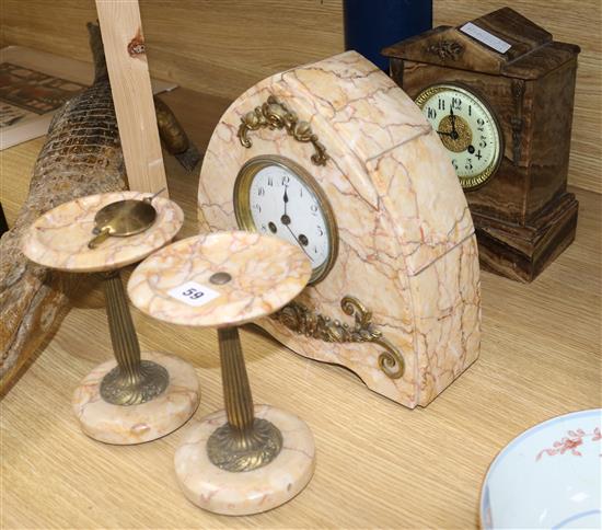 An Art Deco rouge marble clock garniture and similar clock